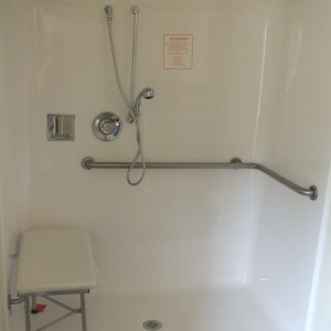 Photo of manufactured home bathroom walk in shower with seat and hand rails