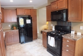 Double wide home 5225-508 kitchen Photo Of Double Wide Home 5225-508 Kitchen With Wood Cabinets And Black Refrigerator