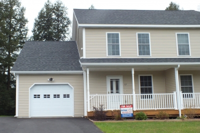 A photo of a cream colored condo home in Berlin Vermont.