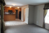 294 stock model single wide home living area A Photo Of Stock Model 294 Single Wide Home Unfurnished Living Area With Bright Window