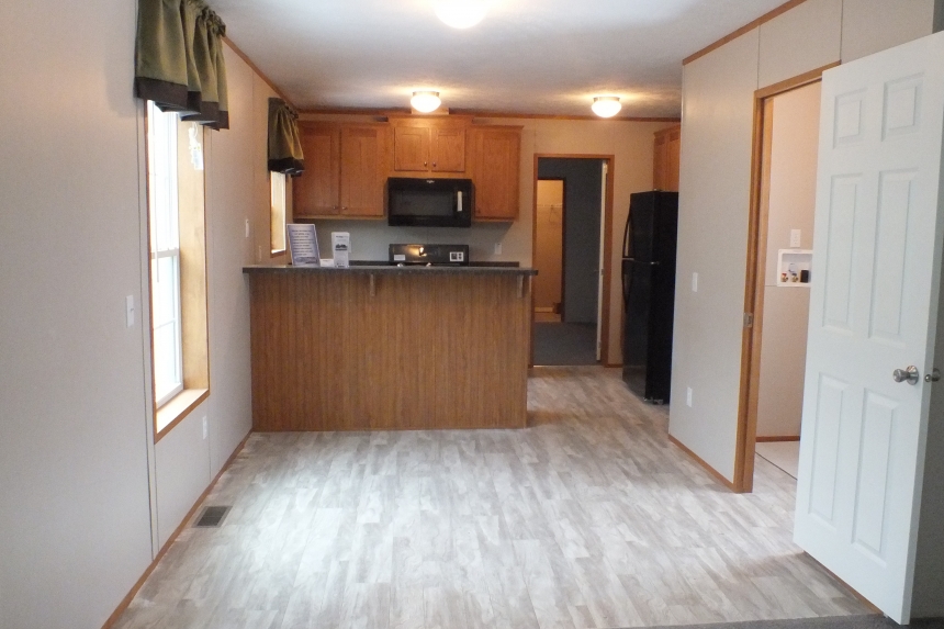 294 stock model single wide home view into kitchen A Photo Of Stock Model 294 Single Wide Home Living Area Looking Into Kitchen