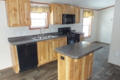 Single wide home in Milton Vermont kitchen with island A Photo Of 141 Milton Vermont Single Wide Home Kitchen With Island And Appliances.