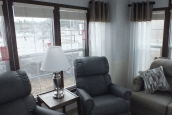The Park Model 7 manufactured home living room A Photo Of Park Model 8 Manufactured Home Furnished Living Room With Sofa And Easy Chairs And Bright Windows.
