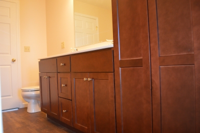 Renting is a great option A photo of brown bathroom cabinets in a manufactured home.