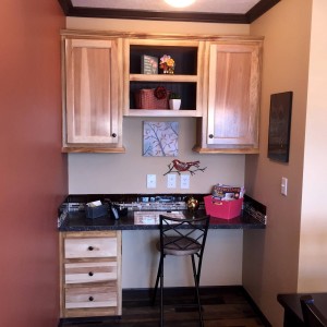Photo of manufactured home interior desk nook with wood drawers and cabinets