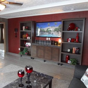 Photo of manufactured home interior living room with television shelving and ceiling fan