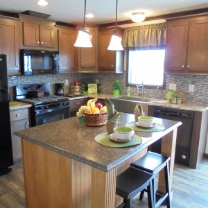 Modular and manufactured home kitchen black refrigerator island and bright window