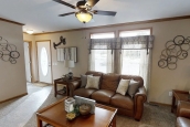Modular home ranch 52J738-JM living area and couch Photo Of Modular Home Ranch 52J738-Jm Furnished Living Area With Ceiling Fan