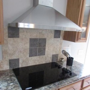 Modular and manufactured home kitchen stove and large silver hood