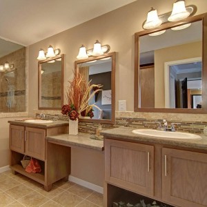 Photo of manufactured home bathroom with bright lights and two vanities and shower