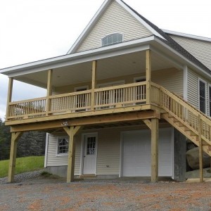 Photo of manufactured home beige exterior with exterior wooden staircase to deck