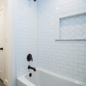 Photo of manufactured home bathroom tub with white tiles