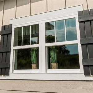 Photo of manufactured home exterior windows with brown shutters
