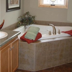 Photo of manufactured home bathroom large tub under a bright window