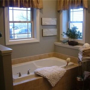 Photo of manufactured home bathroom windows over white tub