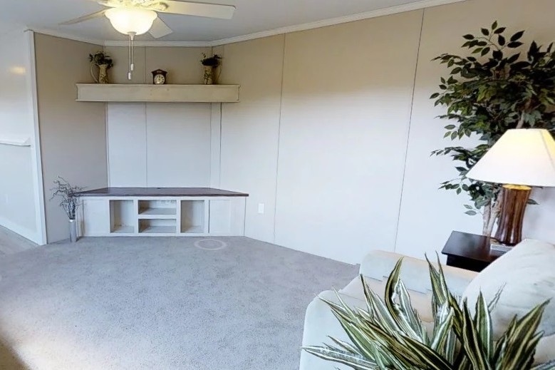 Single wide home 8016-721 living area Photo Of Single Wide Home 8016-721 Furnished Living Room With White Sofa Plants And Lamp