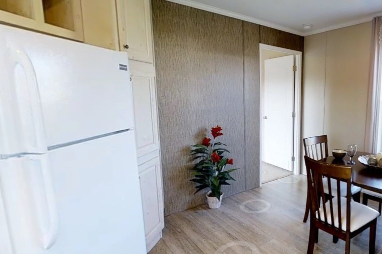 Single wide home 8016-721 dining area Photo Of Single Wide Home 8016-721 Dining Area Seen From Kitchen With White Refrigerator