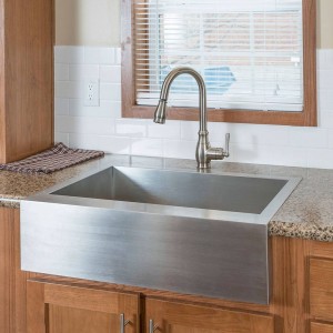 Modular and manufactured home kitchen sink and faucet near bright window