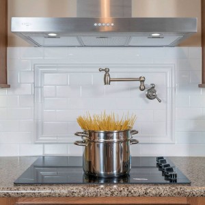 Modular and manufactured home kitchen stove with pot of uncooked spaghetti