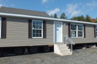 A photo of the exterior of a a three bedroom brown double wide home.