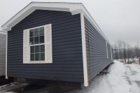 A photo of a blue single-wide manufactured home in Chittenden County Vermont.