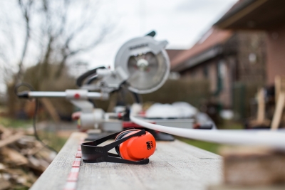 A photo of a circular saw and hearing protection.